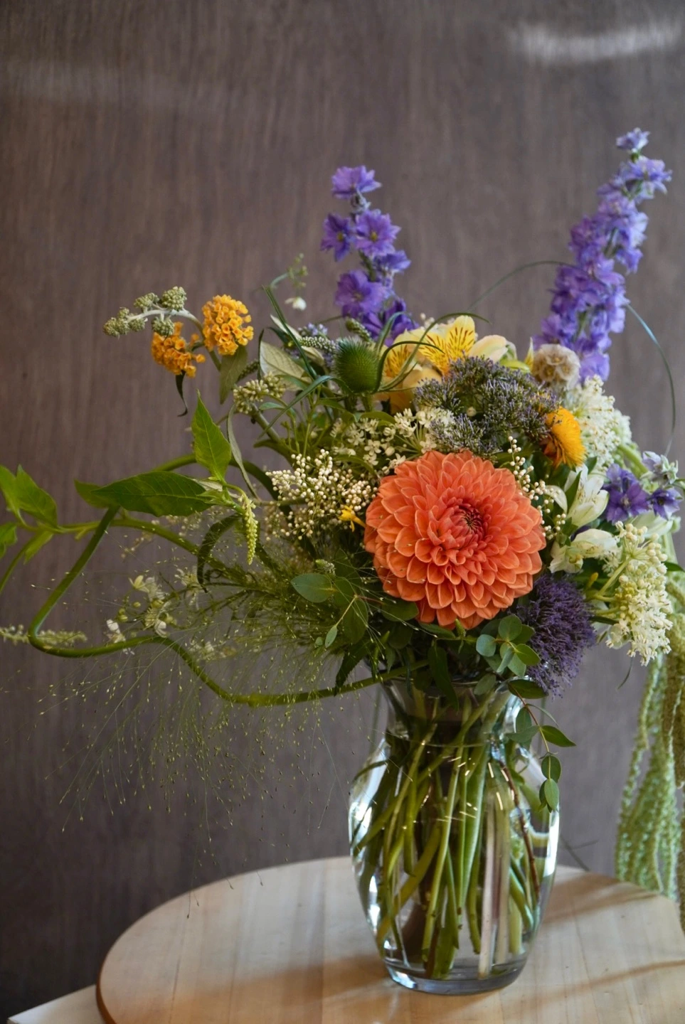 Seasonal flowers with orange blooms, lilac accents and natural botanical texture