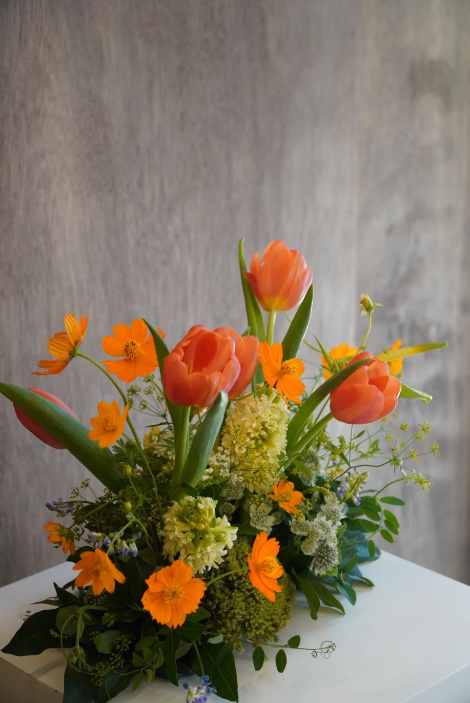 Orange tulips and seasonal flowers